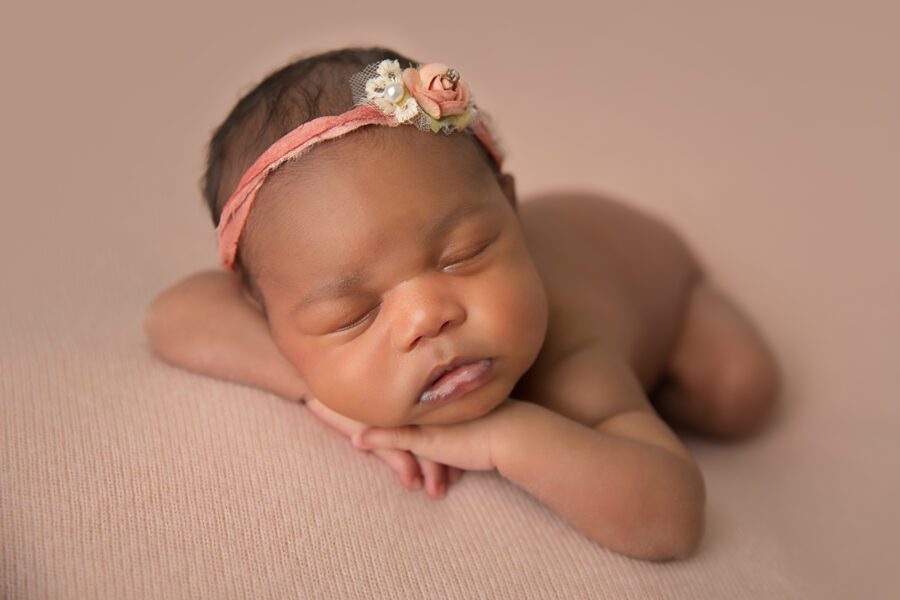 allas newborn photographer capturing baby wrapped in soft neutrals