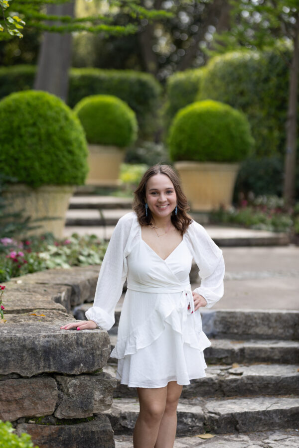 Senior girl smiling at golden hour, captured by a senior photographer in Dallas specializing in natural, relaxed portraits.
